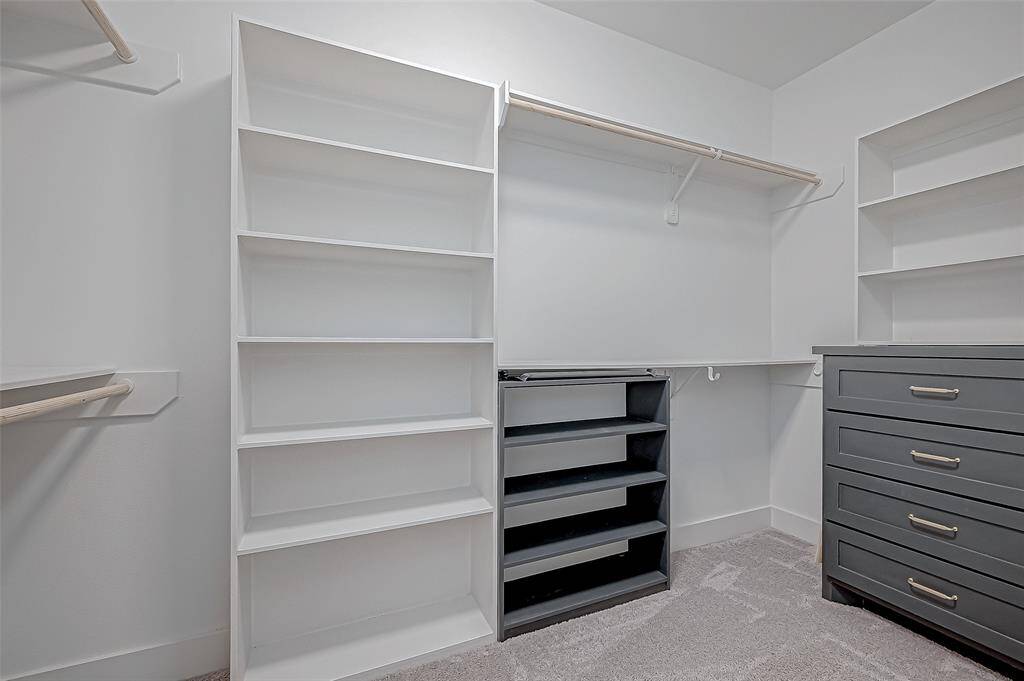 One of 2 walk-in closets in the Primary Room, with well organized shelves and built in drawers. Tons of space…