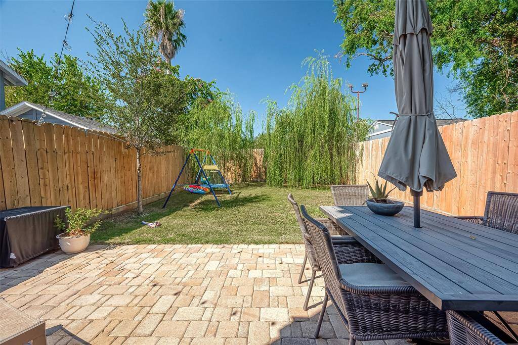 This back yard not only has a tall fence for privacy, large cozy patio area, but also a large green space area. It is  Large enough for a pool, if desired.