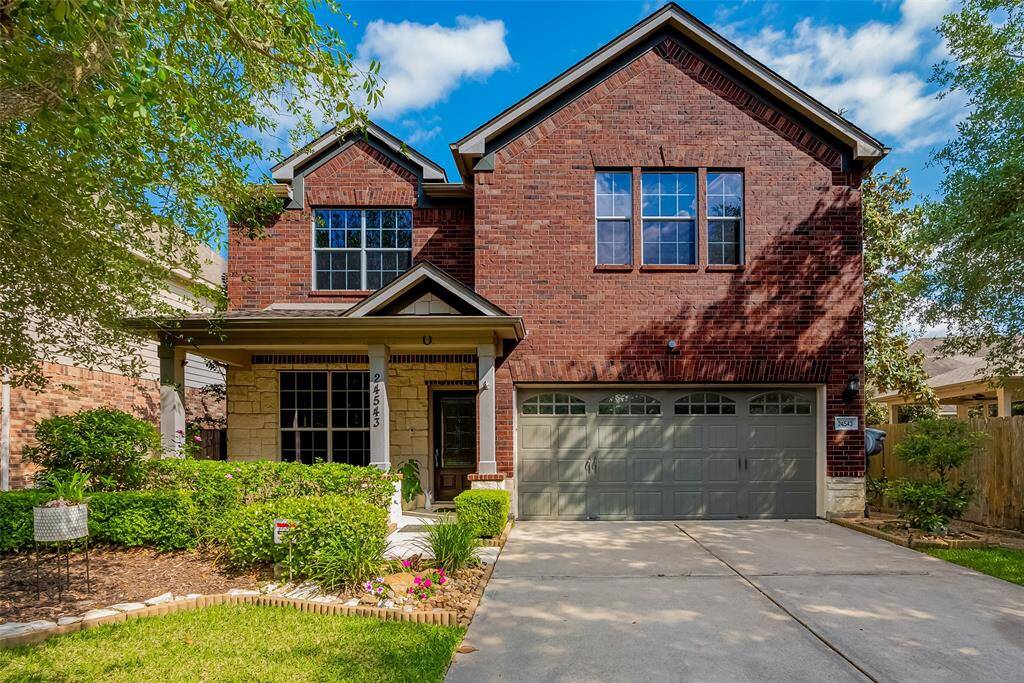 Beautiful two-story brick home with covered porch, and spacious two-car garage in a quiet neighborhood.