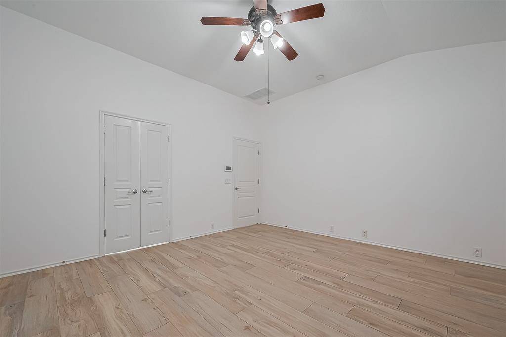 Another view of the spacious primary bedroom with ample natural light.