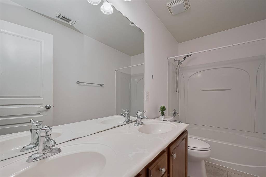 Elegant upstairs bathroom featuring dual vanities.