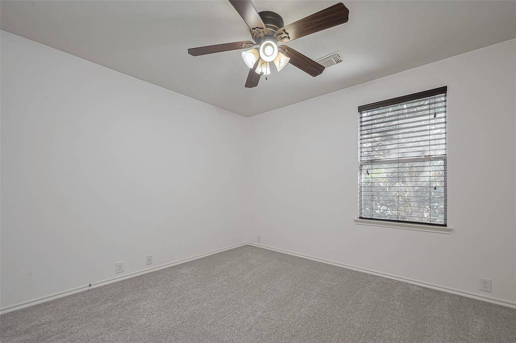 Third upstairs bedroom with walk-in closet and ceiling fan for comfort.