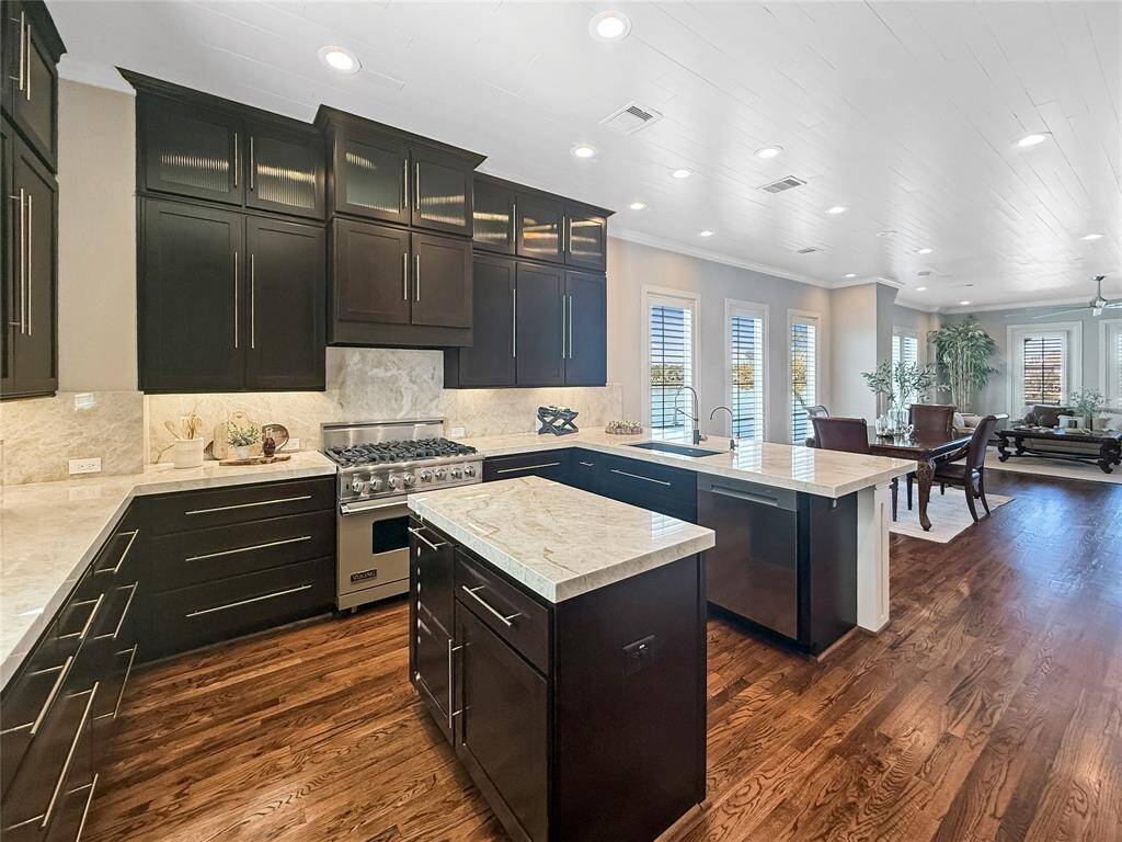 The kitchen, complete with an island,, seamlessly flows into the dining and family rooms, which feature a cozy fireplace.