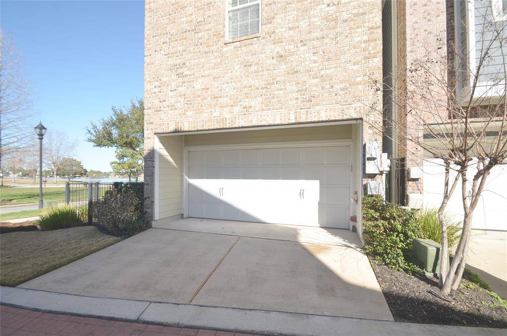 Private driveway providing access to the garage. Two-car garage featuring durable epoxy flooring.