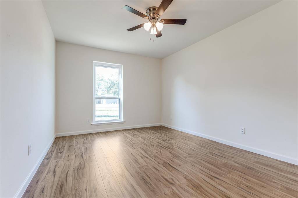 Another versatile bedroom or potential office space, featuring new windows, neutral tones, and fresh flooring—endless possibilities await