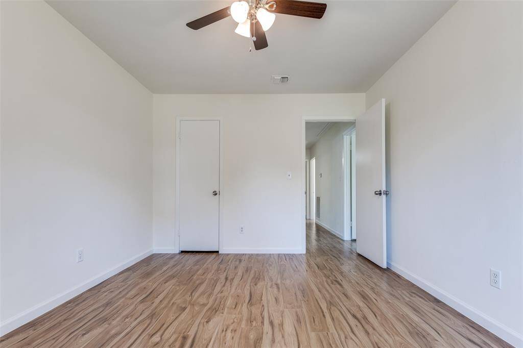 Another versatile bedroom or potential office space, featuring new windows, neutral tones, and fresh flooring—endless possibilities await