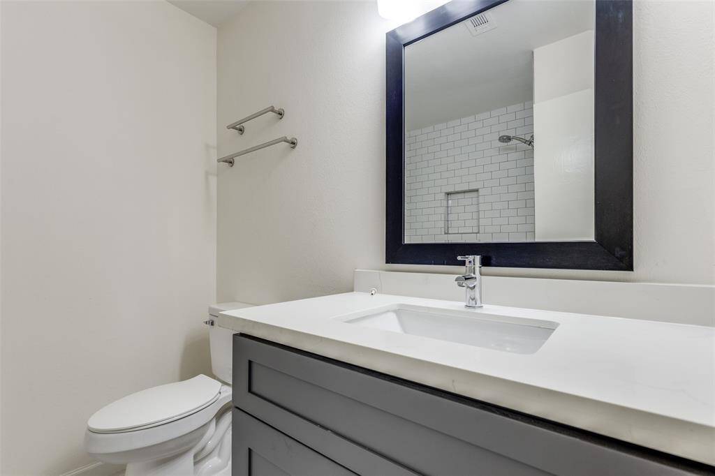 But wait, there's more! The secondary bathroom features matching colors and a renovated shower, ensuring your guests or family have a stylish space to enjoy