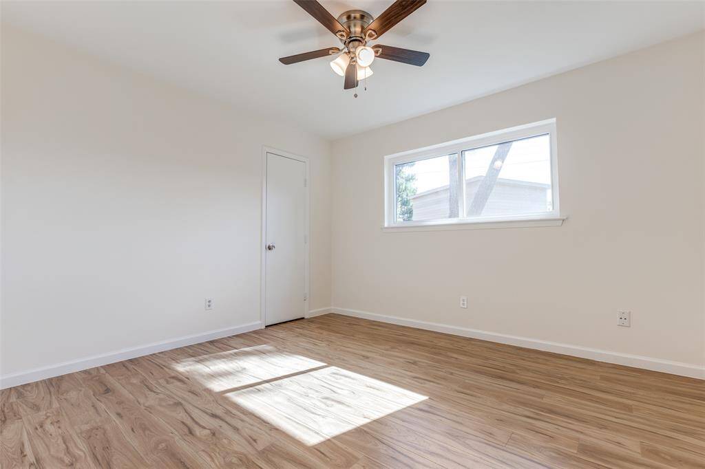 Another versatile bedroom or potential office space, featuring new windows, neutral tones, and fresh flooring—endless possibilities await