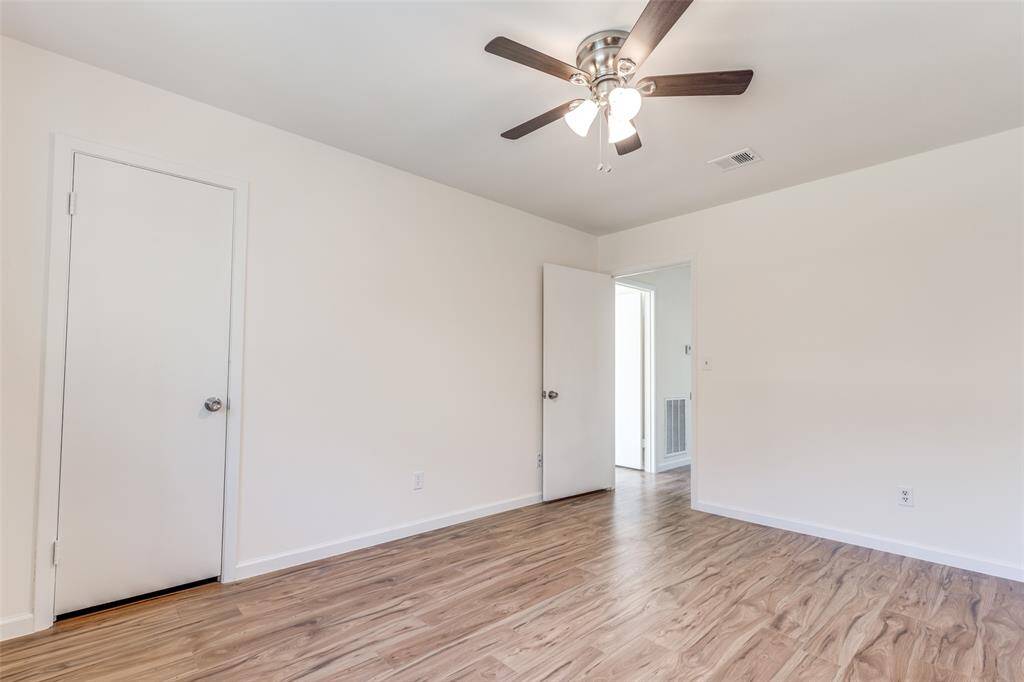 Another versatile bedroom or potential office space, featuring new windows, neutral tones, and fresh flooring—endless possibilities await