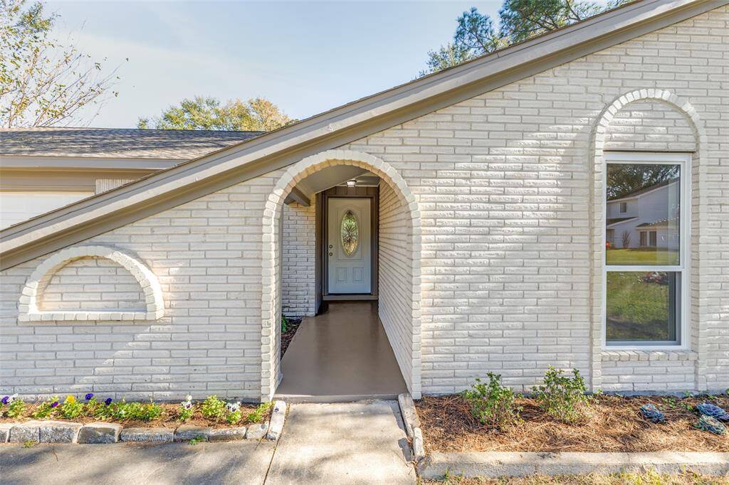 Front entrance features a charming courtyard, perfect for creating your dream Spring garden retreat