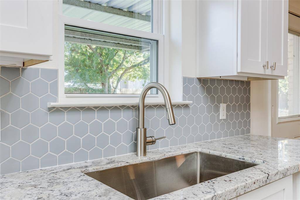 Imagine doing dishes while enjoying a serene backyard view, with natural daylight making chores feel effortless