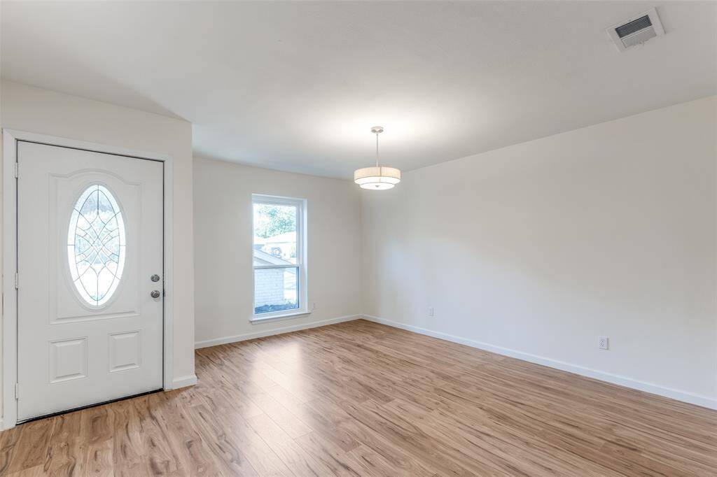 Step inside to an expansive open living area, offering versatile space that can easily accommodate a formal dining room or a home office, tailored to your needs