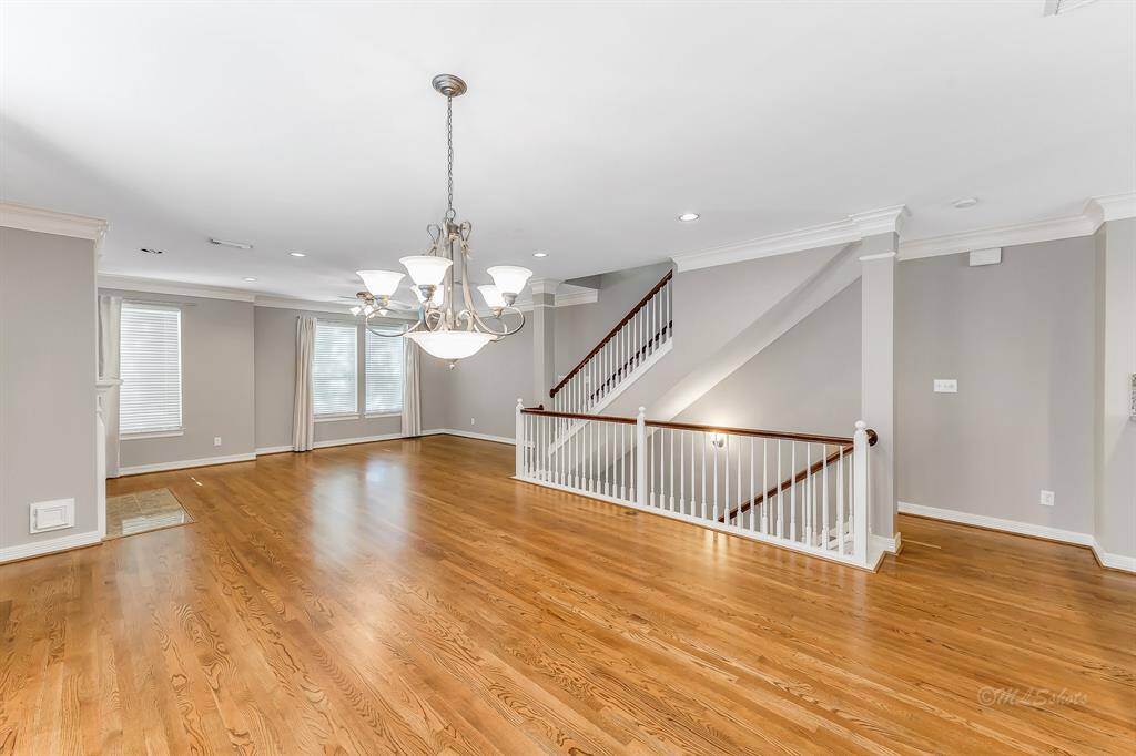 Another wonderful view of the formal dining room as you and your guests move to the living room. Notice the recessed lighting through out as the beautiful banister leads you to the master bedroom and media room located on the third floor.