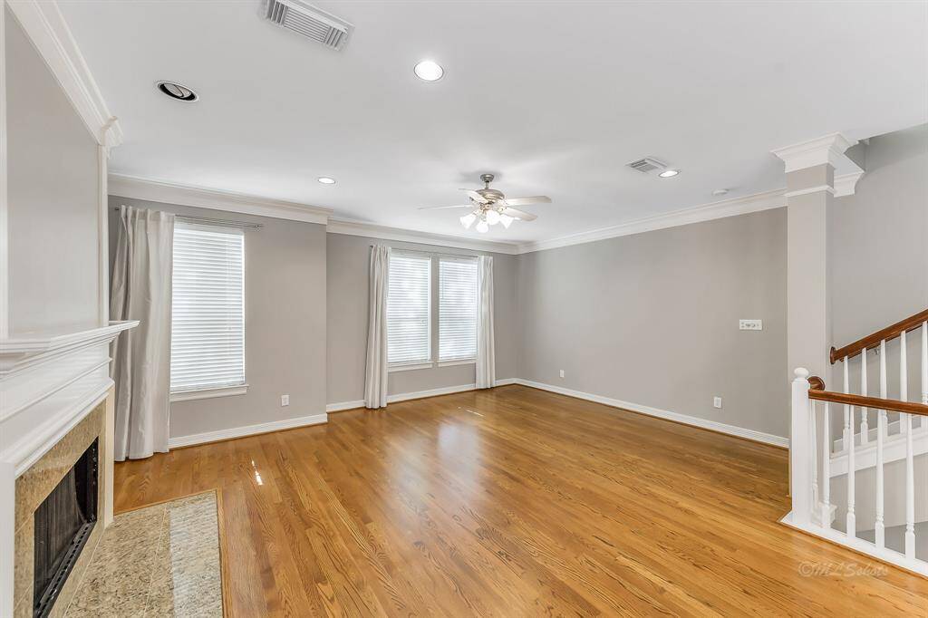 You will enjoy entertaining your guests in the spacious living room.  Bright windows, a cozy fireplace, crown molding, and neutral paint make this an inviting space.