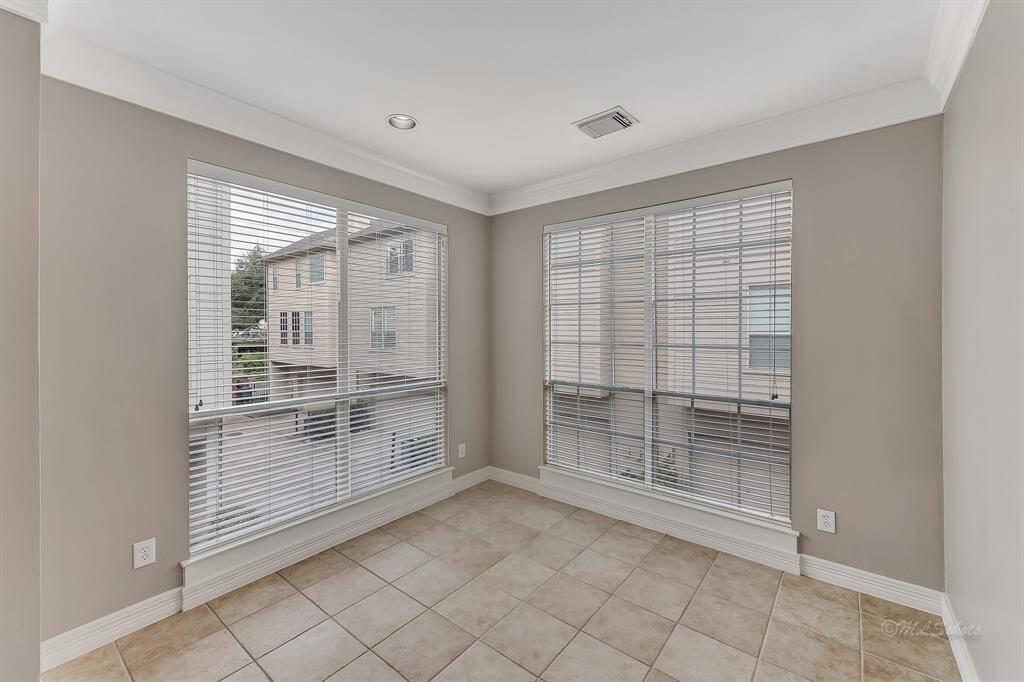 The breakfast area is adjacent to the kitchen and features bright windows, recessed lighting and crown molding.  Enjoy your coffee and the view in the morning!