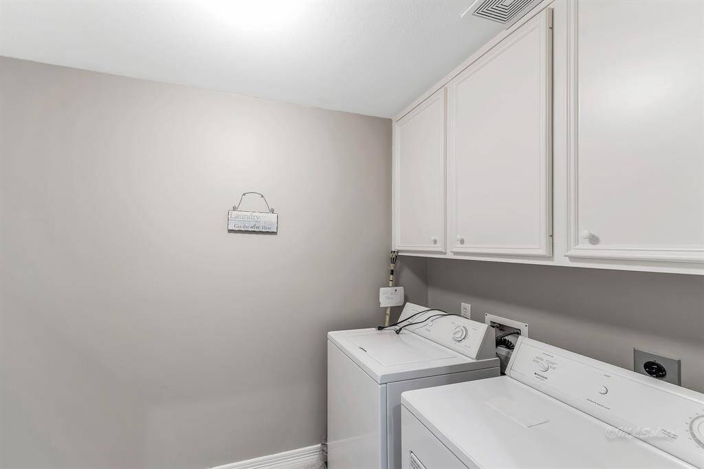 The laundry room is located on the third floor. Storage keeps all of your supplies tucked away neatly.