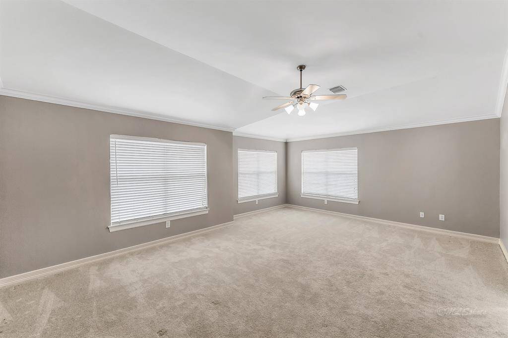 Welcome to your master retreat!  At nearly 22'x14', there is plenty of space for a king size furniture suite and a seating area!  The room features three large windows, neutral paint, crown molding, a vaulted ceiling, and a ceiling fan.  The third story views overlook the beautiful townhome community.