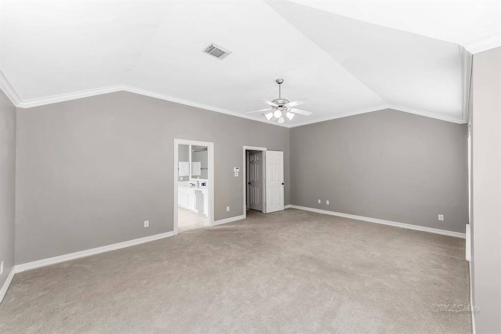 The en suite master bathroom is through the door on the left.  The door on the right leads to the third floor landing.  An extra storage closet is located just outside the bedroom.