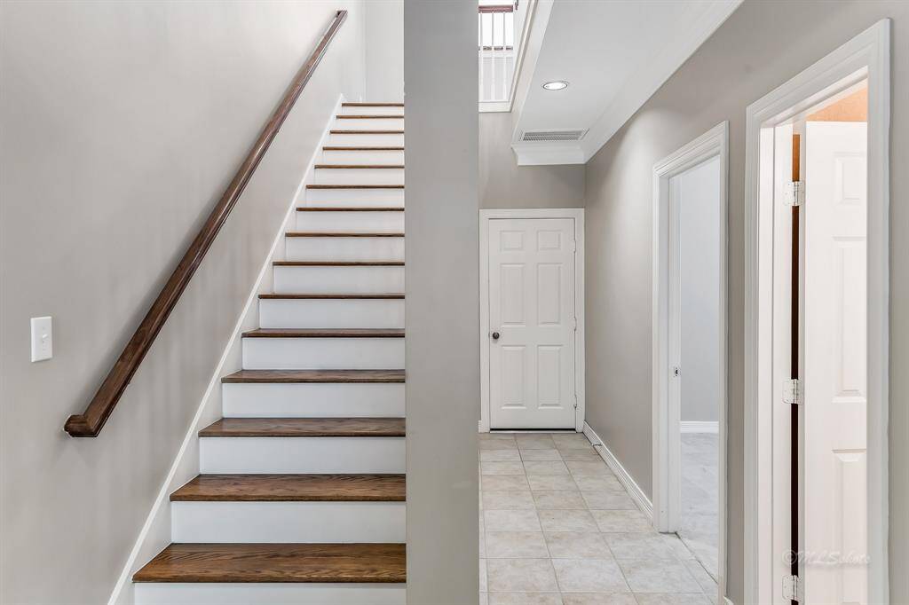 As you enter the foyer, you'll enjoy the beautiful wood stairs, 9' ceilings with crown molding, decorator neutral paint and recessed lighting.