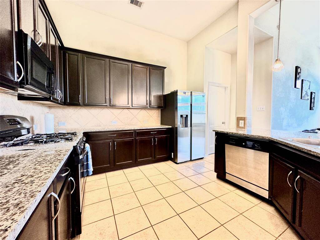 Plenty of cabinets and stainless steel fridge included.
