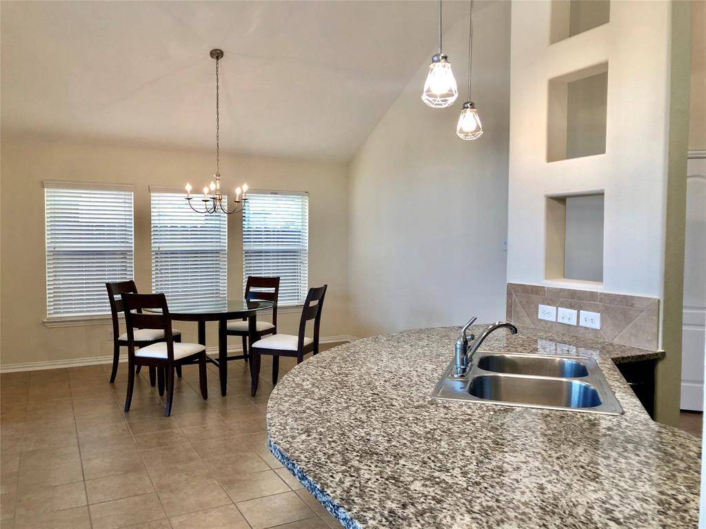 Contemporary open kitchen that flows to the elegant dining room. (Previous photo showing dining area and breakfast bar)