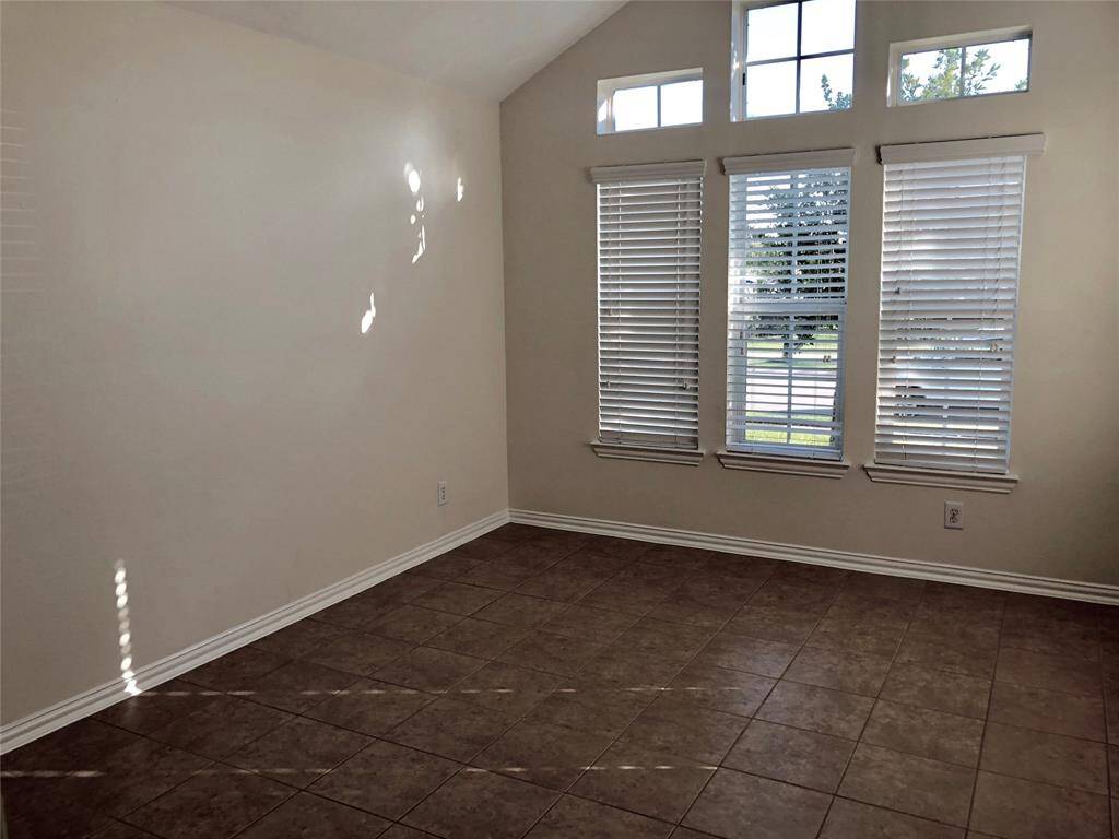 Secondary bedroom with cathedral ceilings. Enjoy the wonderful view to the front yard and park across the street. (previous photo)
