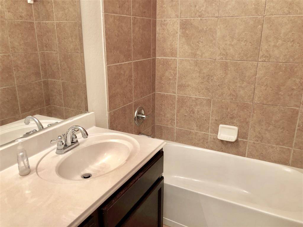 Secondary bathroom with a relaxing tub. and shower