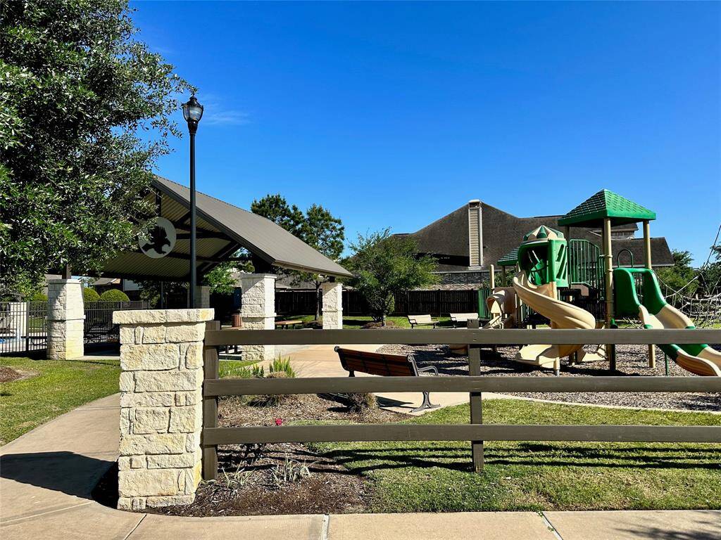 Playground with covered picnic area next to pool area