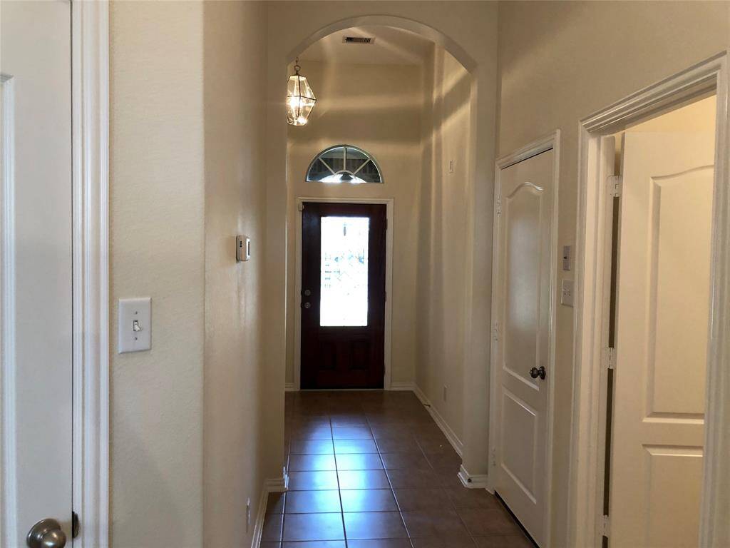 Elegant entry hall with high ceilings.