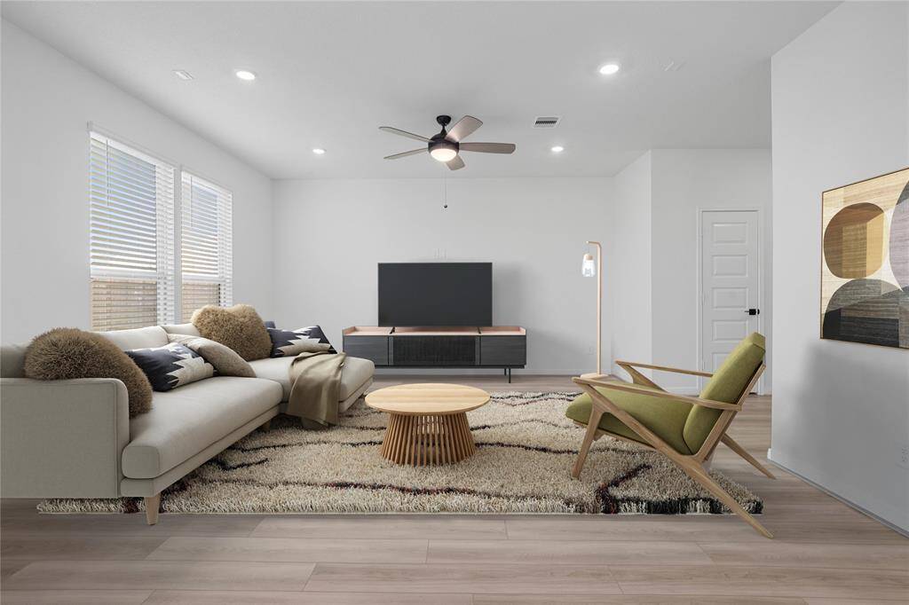 This light and bright spacious great room is the perfect layout for entertaining or just relaxing. Whether it's simply a night in or entertaining family and friends, this home has ample open space for everyone to enjoy! Featuring tile flooring, large windows with privacy blinds, high ceilings with ceiling fan, recessed lighting with wonderful access to your gorgeous kitchen.