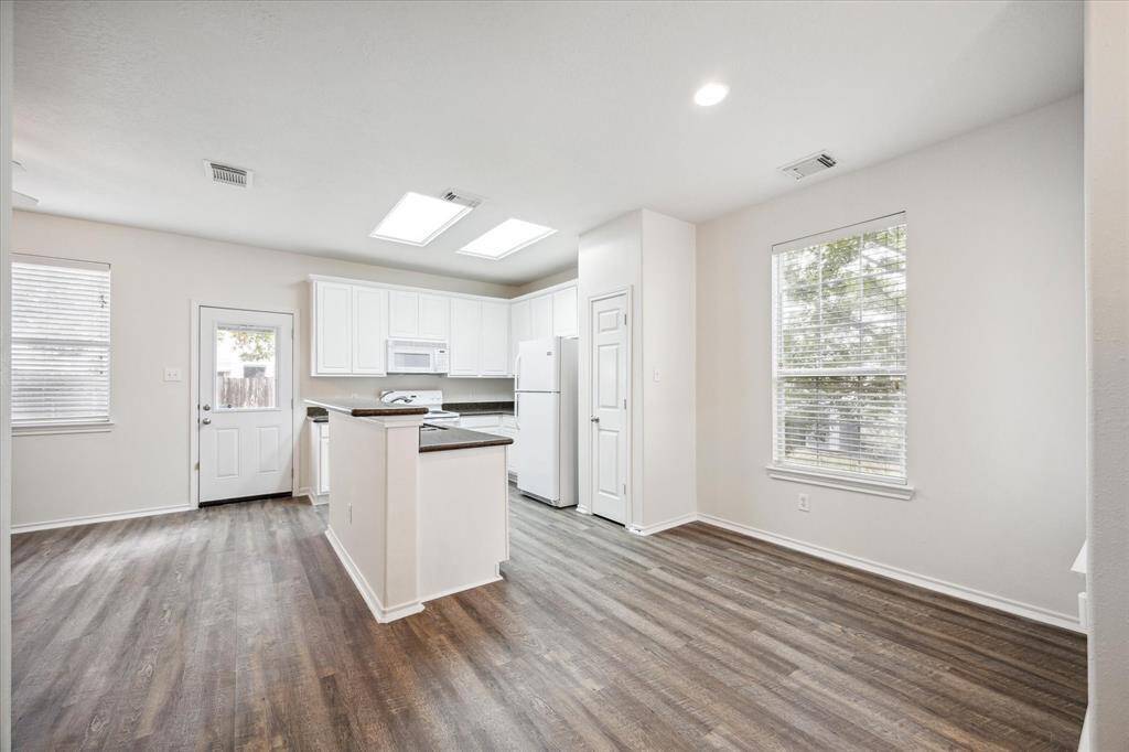 This sought-after floor plan offers seamless flow between the dining area, kitchen, and living room. The gorgeous flooring beautifully complements the granite countertops in the kitchen, creating a cohesive and stylish living space.