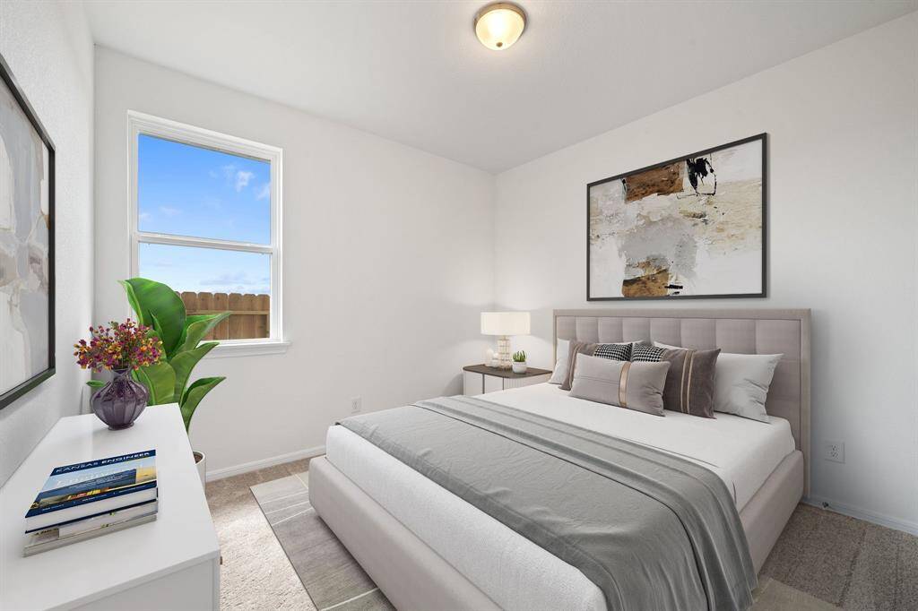 Your secondary bedroom features plush carpet, fresh paint, closet, and a large window that lets in plenty of natural lighting.