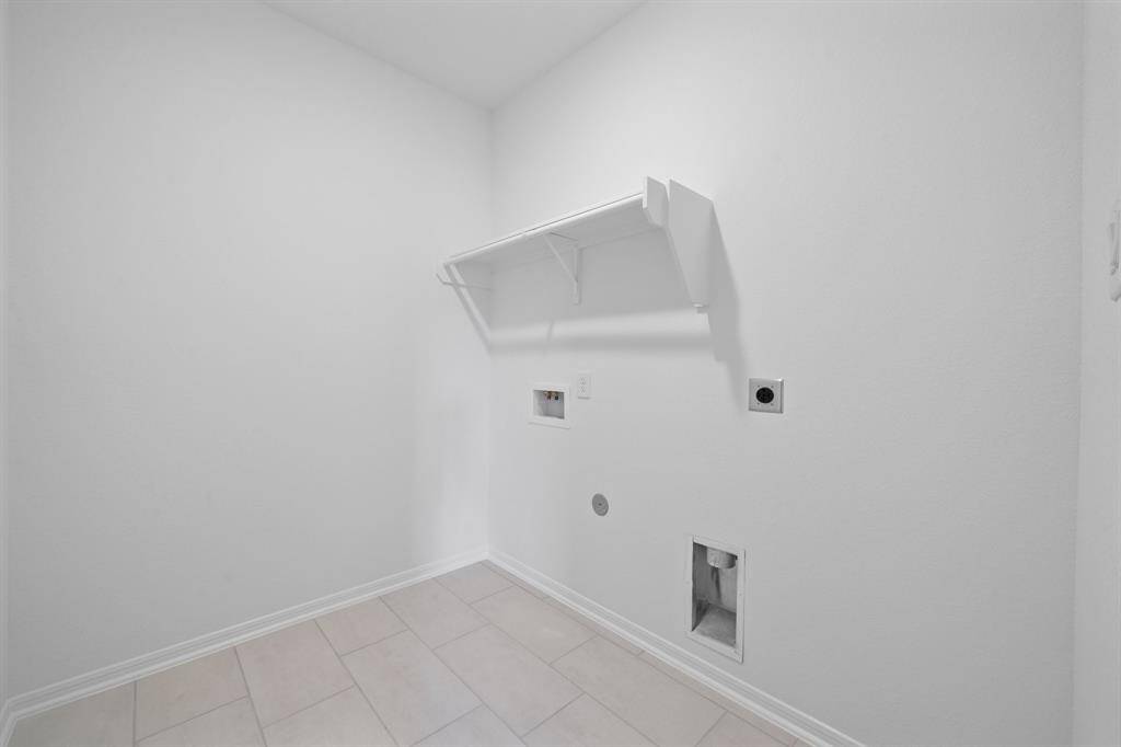 The laundry room layout is carefully planned for optimal workflow with designated areas for washing, drying, and storing.