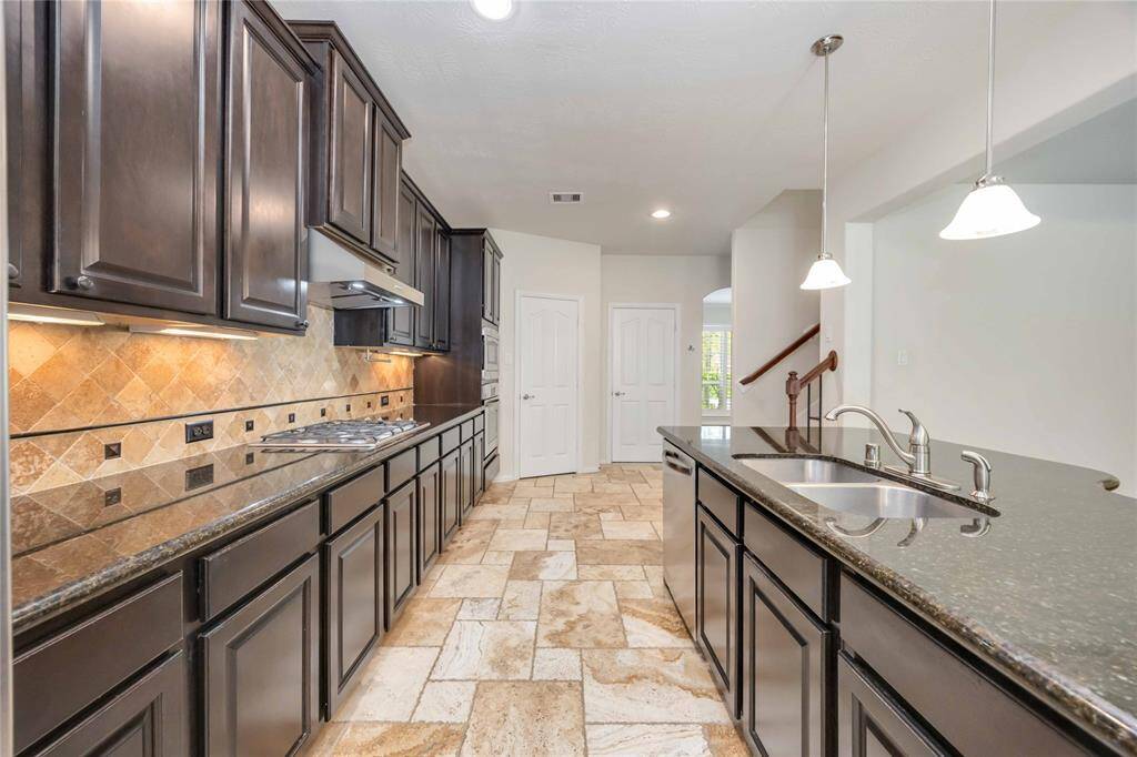 You'll love all the storage and granite counter space! The stylish backsplash is highlighted by the under cabinet lighting.