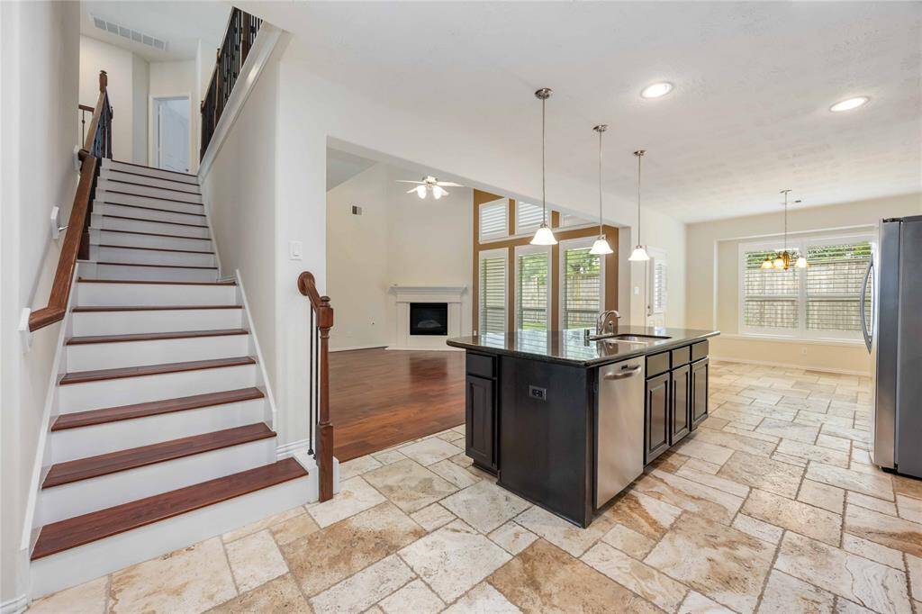 A second stair case rests off the kitchen.