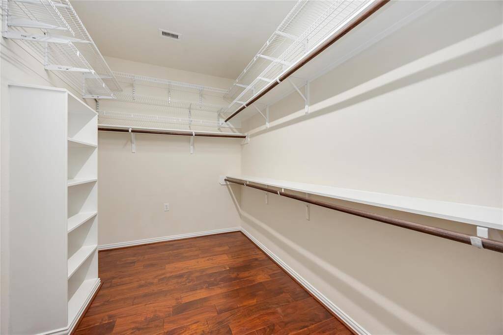 A huge walk-in closet in the primary suite includes plenty of built-in shelving!
