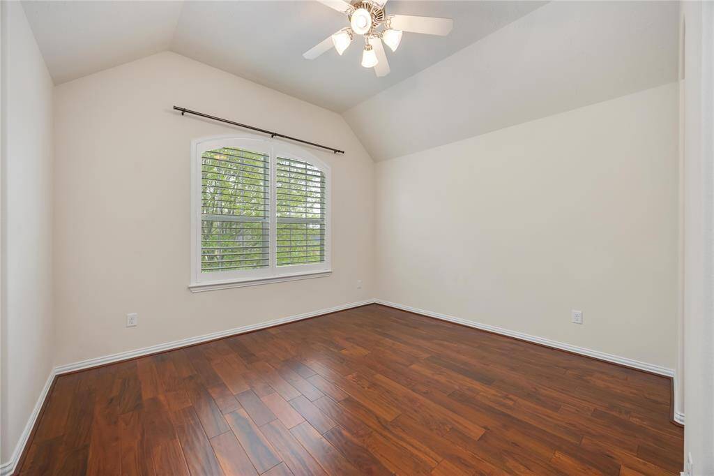 Bedroom 4 offers a high ceiling and a nice view of the trees.