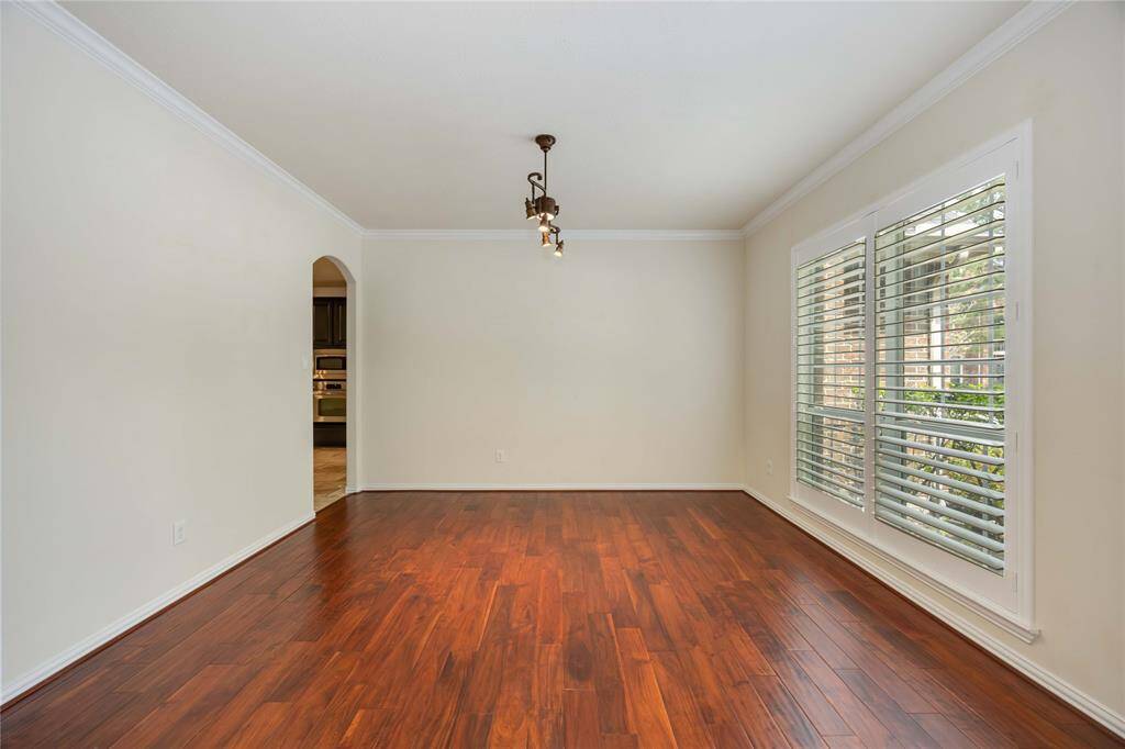 The formal dining is spacious enough for a large table and plenty of seating. It connects to the kitchen through the arched opening.