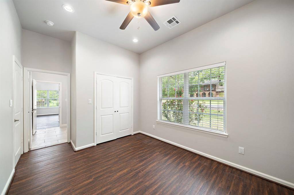 Step into comfort and style in this beautifully updated secondary bedroom featuring brand new luxury vinyl plank flooring that combines elegance with easy maintenance. Abundant natural light pours through a large window, offering serene views and creating a bright, cheerful ambiance. This room shares a convenient Jack and Jill bathroom with the adjacent secondary bedroom—ideal for guests or family members. Whether you're unwinding after a day on the golf course or getting ready for a lakeside adventure, thi