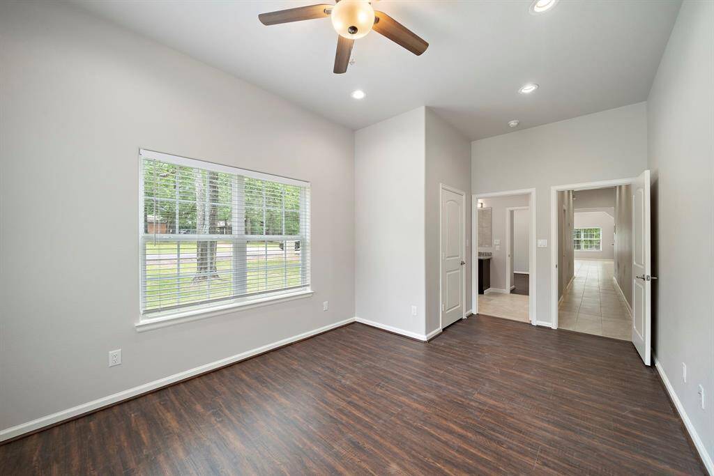 Step into comfort and style in this beautifully updated secondary bedroom featuring brand new luxury vinyl plank flooring that combines elegance with easy maintenance. Abundant natural light pours through a large window, offering serene views and creating a bright, cheerful ambiance. This room shares a convenient Jack and Jill bathroom with the adjacent secondary bedroom—ideal for guests or family members. Whether you're unwinding after a day on the golf course or getting ready for a lakeside adventure, thi