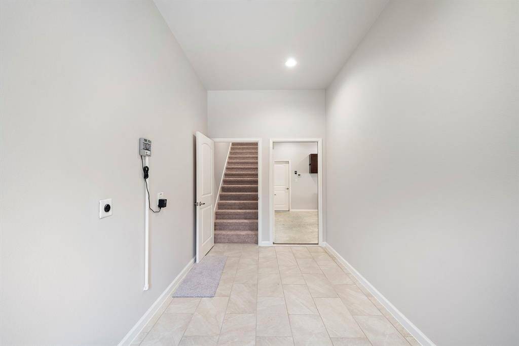 Tucked away off a private secondary entrance, this unique feature opens the door—literally—to endless possibilities. A carpeted staircase leads to a spacious upper-level retreat that can easily serve as a game room, 4th bedroom, home office, or even a creative studio. Whether you're hosting grandkids, working remotely, or simply seeking a quiet space to relax, this area offers the flexibility to meet your needs.With direct access and separation from the main living area this space is ideal.