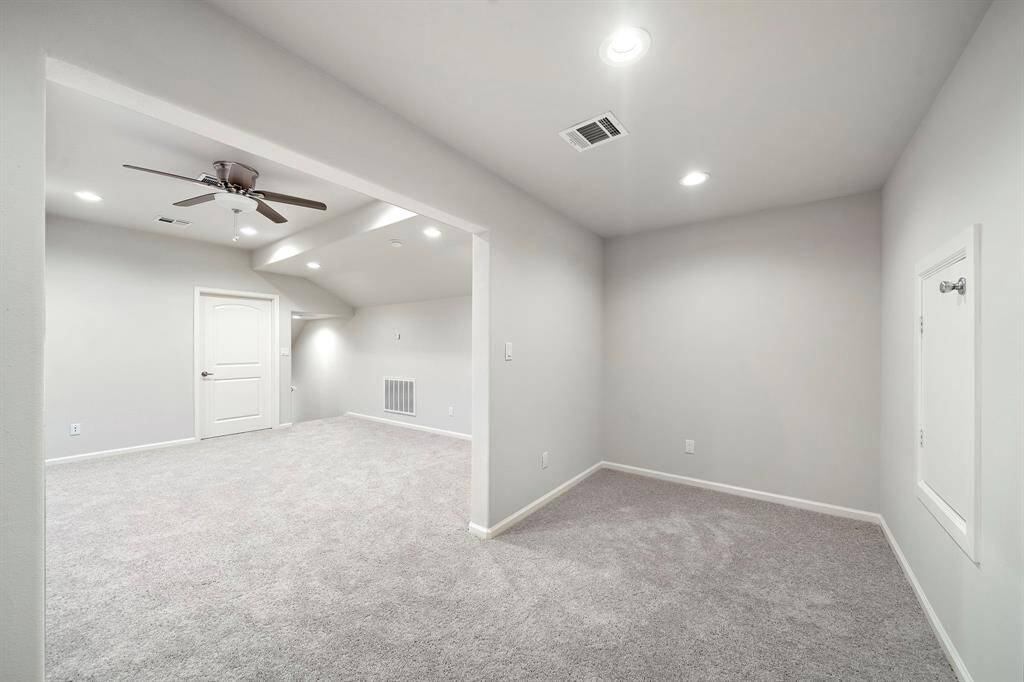 This beautifully updated upstairs retreat offers boundless possibilities—perfect as a game room, guest suite, home office, or 4th bedroom. Accessible through its own private entrance, this space is freshly upgraded with brand new plush carpet and crisp, neutral paint, creating a clean and modern feel throughout. Recessed lighting and a ceiling fan add comfort and style, while the layout includes an open bonus nook ideal for a reading lounge, homework zone, or creative corner.