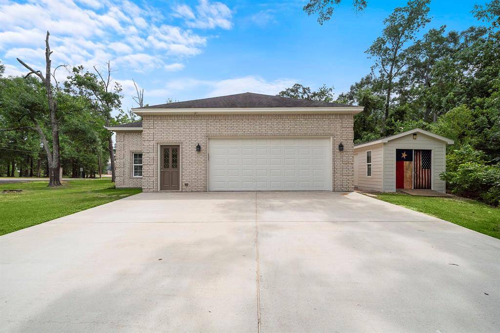 From the street, you're welcomed by a spacious concrete driveway leading to an impressive 4-car garage—perfect for vehicles, golf carts, and all your outdoor gear. A separate shed sits nearby, providing additional storage or workspace. The setup includes a private secondary entrance for easy access and extra flexibility. And with direct access to the golf course from the drive, you're only moments away from your next tee time.