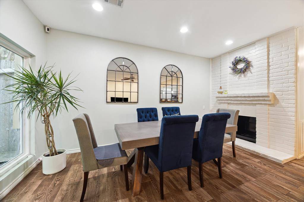 Cozy dining room featuring an inviting wood-burning fireplace, perfect for intimate dinners and warm gatherings.