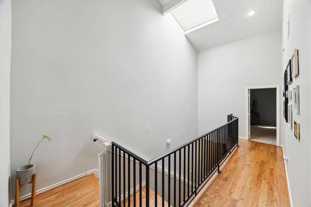 Experience the airy ambiance of the upper landing, enhanced by soaring ceilings and abundant natural light.