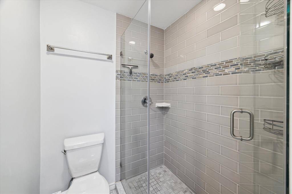 Modern en-suite bathroom with sleek, updated shower.