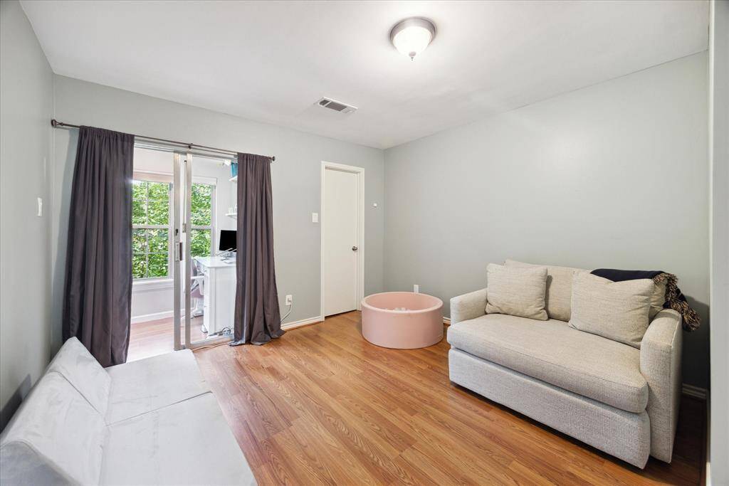 Versatile second bedroom with direct access to a cozy, enclosed flex space, currently styled as a charming playroom.