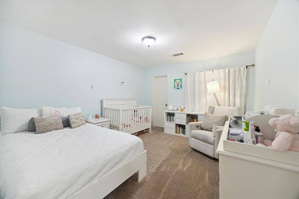 Spacious third bedroom featuring an ample walk-in closet for generous storage.
