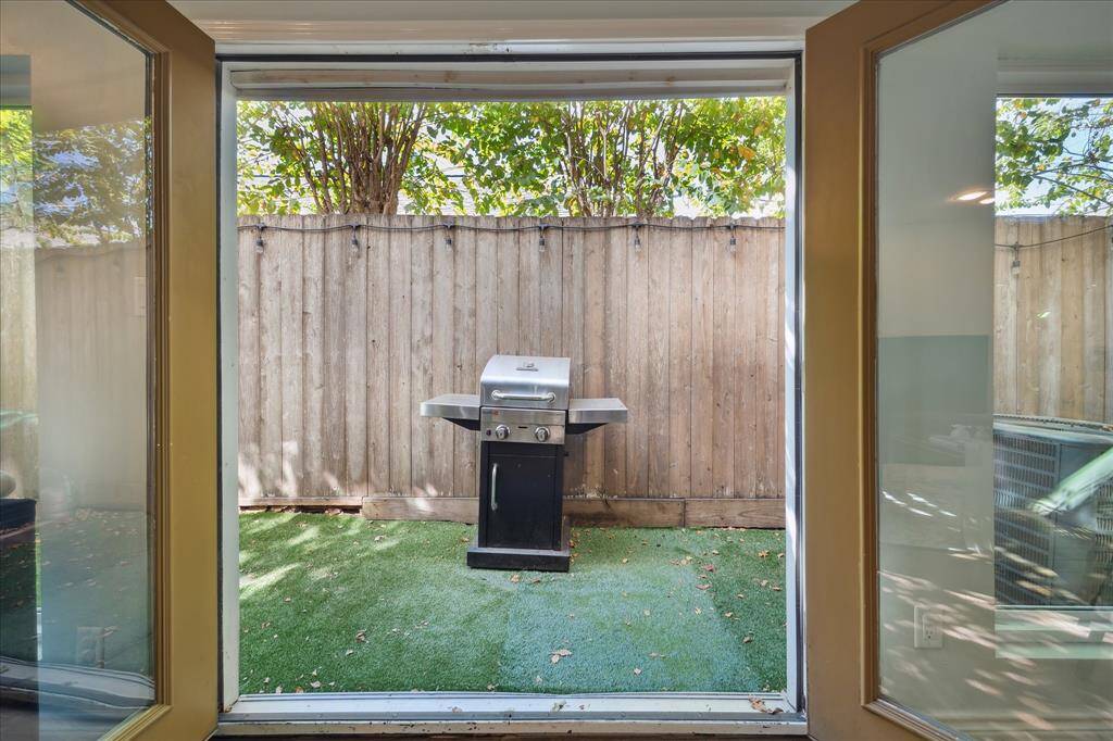 French doors lead out to the freshly turfed backyard. The beautiful trees provide a lovely view and great shade.