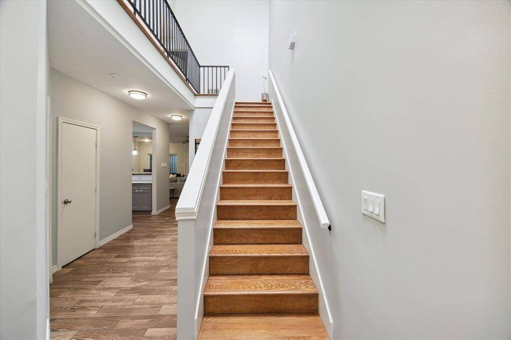 Step into a soaring 25-foot ceiling space bathed in sunlight from a brand-new skylight, creating an inviting and expansive atmosphere the moment you enter.